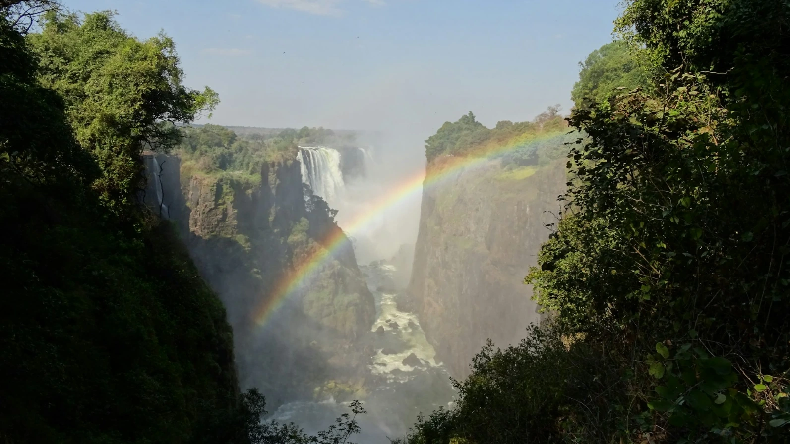 a rainbow in the middle of a waterfall